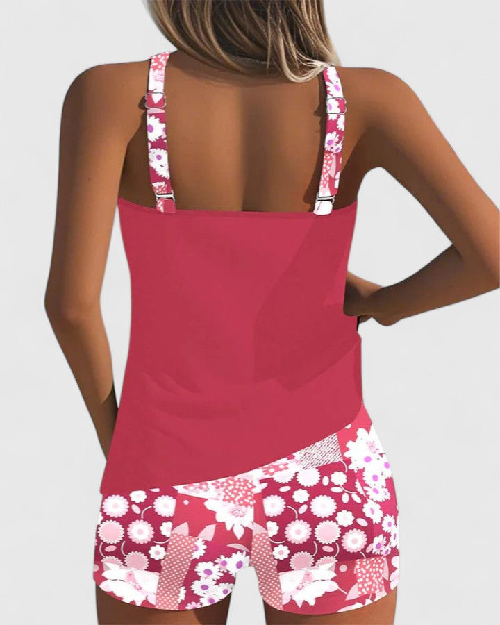 Pink tank top and floral shorts set on a plain background