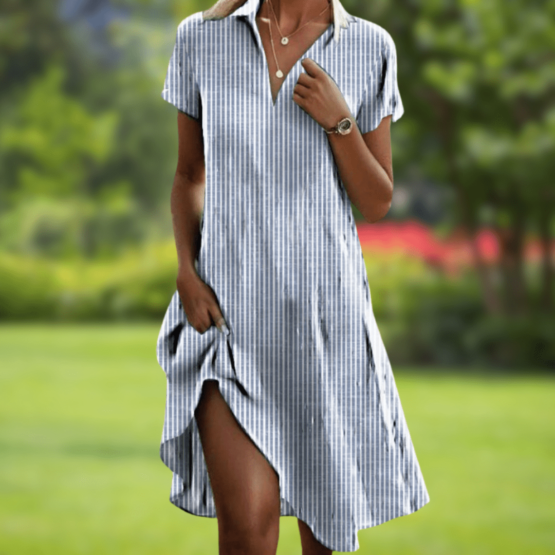 Woman wearing a blue and white striped dress in a garden setting
