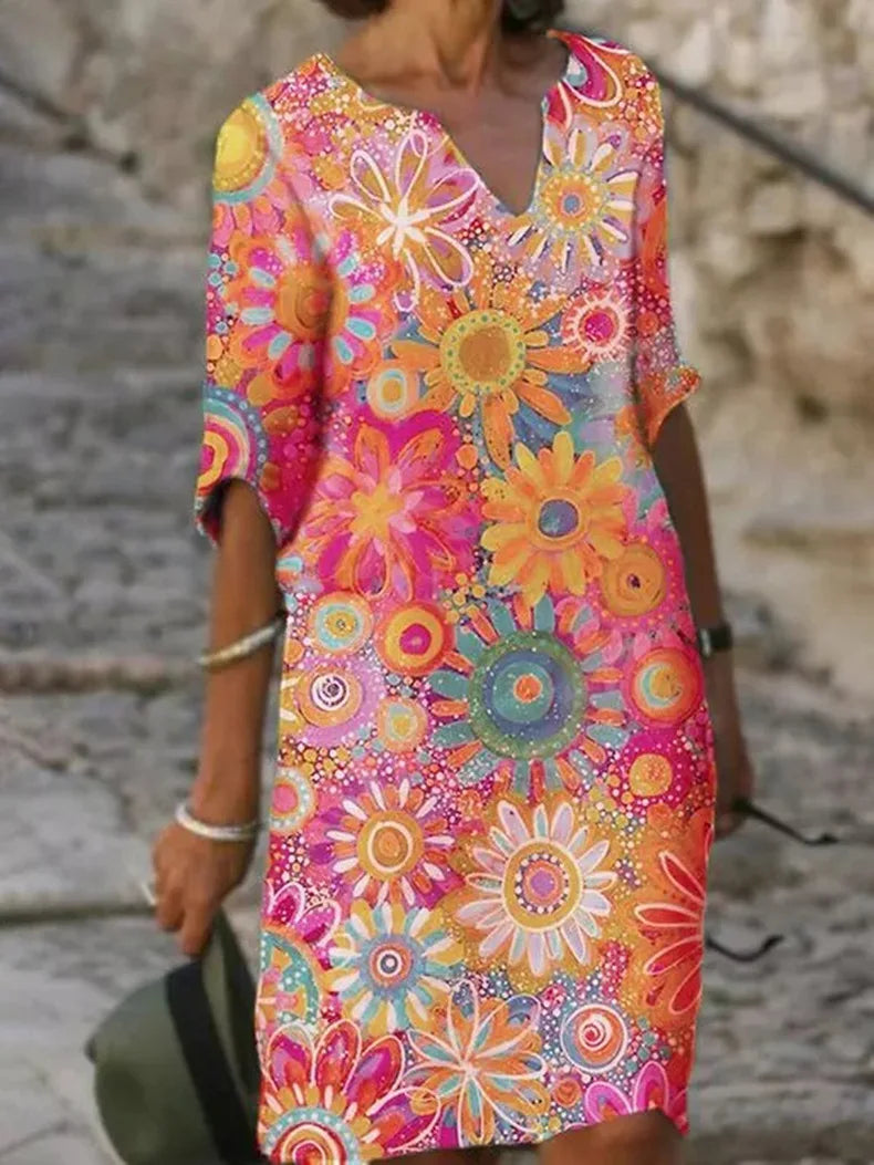 Colorful floral dress worn by a person on a stone staircase.