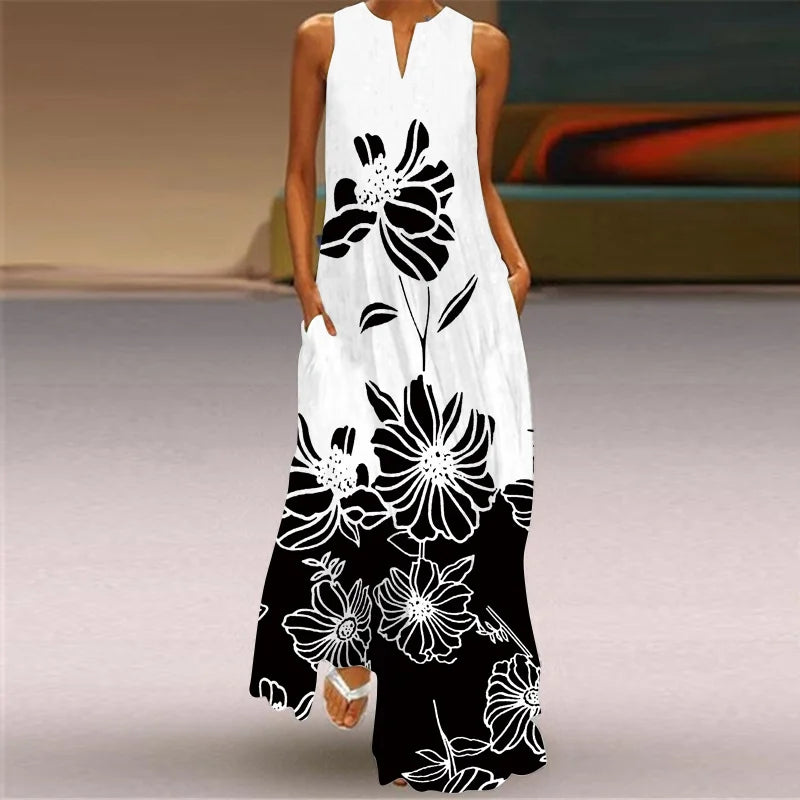 White sleeveless dress with black floral patterns on a neutral background