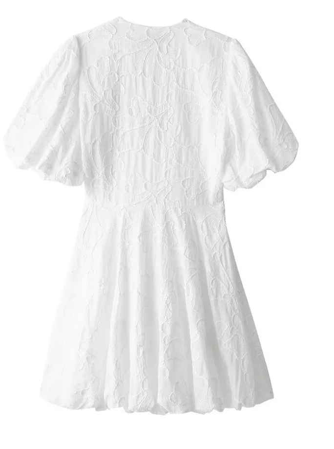 White dress with lace detailing on a white background