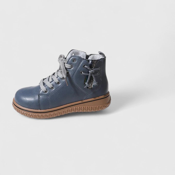 Blue children's boot with brown sole on a light gray background