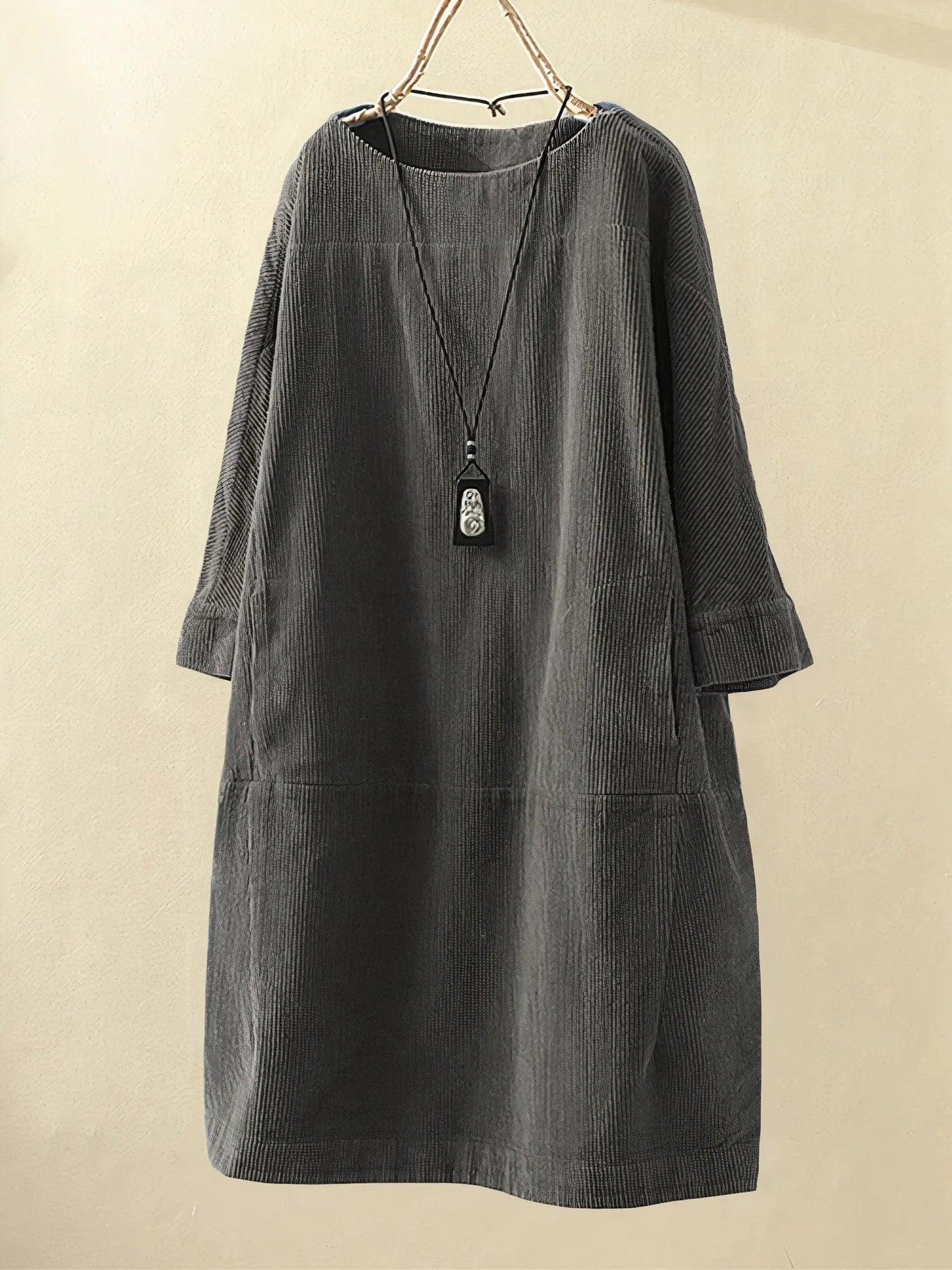 Gray corduroy dress on a beige background