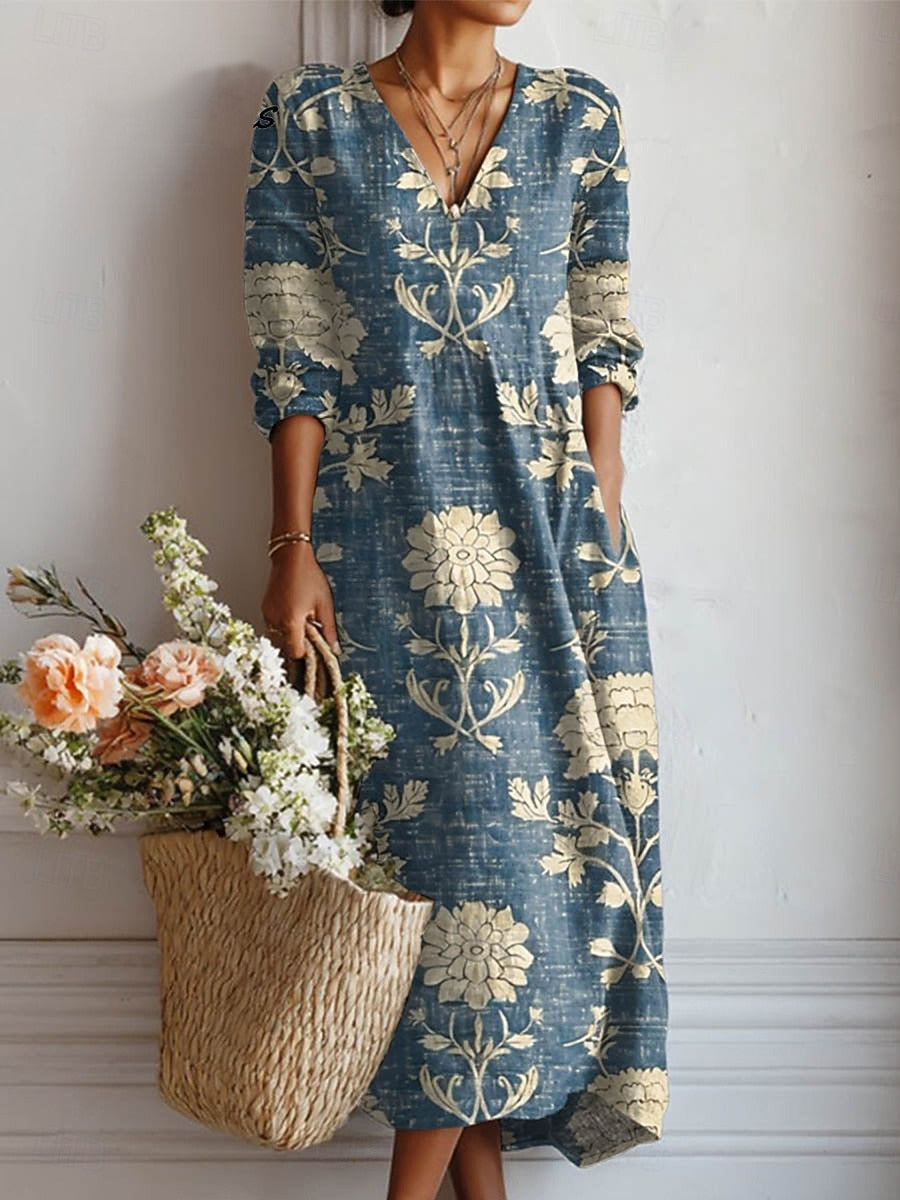 Woman wearing a blue floral dress holding a woven bag with flowers against a white background