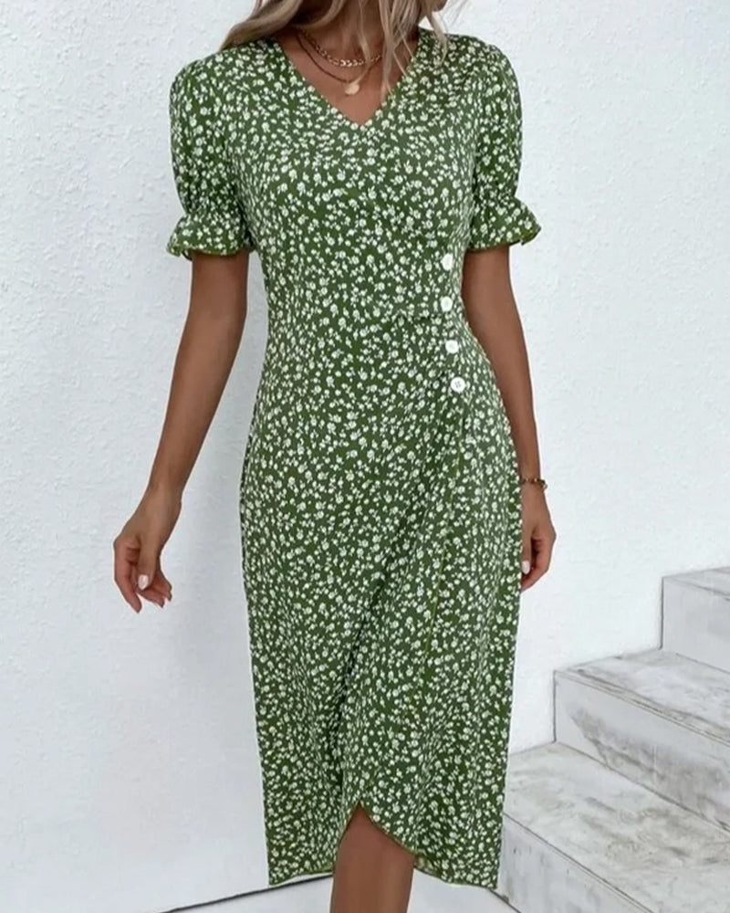 Woman wearing a green floral dress against a white background