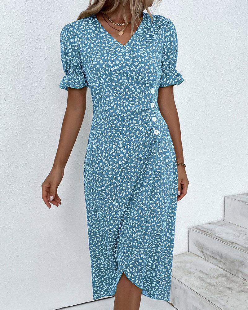 Woman wearing a blue floral dress against a white background