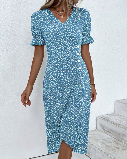 Woman wearing a blue floral dress against a white background