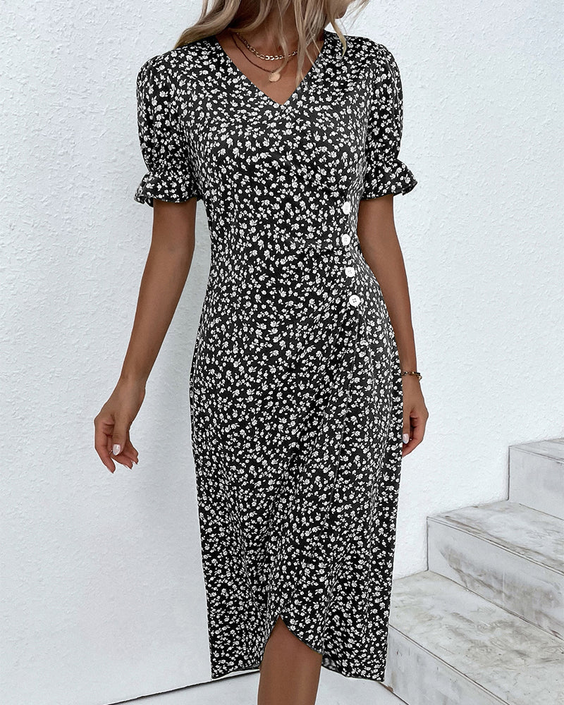 Woman wearing a black and white floral dress against a white background
