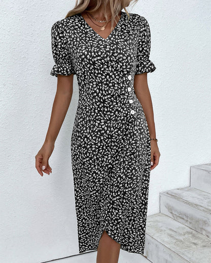 Woman wearing a black and white floral dress against a white background
