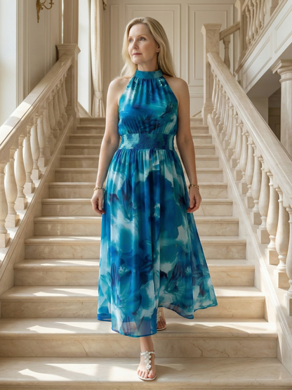 Woman in a blue tie-dye dress standing on a staircase
