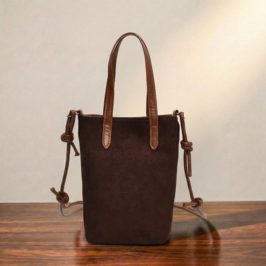 Brown leather crossbody pouch with top handles and adjustable strap, minimalist small shoulder bag for women, compact everyday leather handbag.