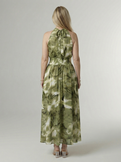 Woman wearing a green tie-dye dress on a white background