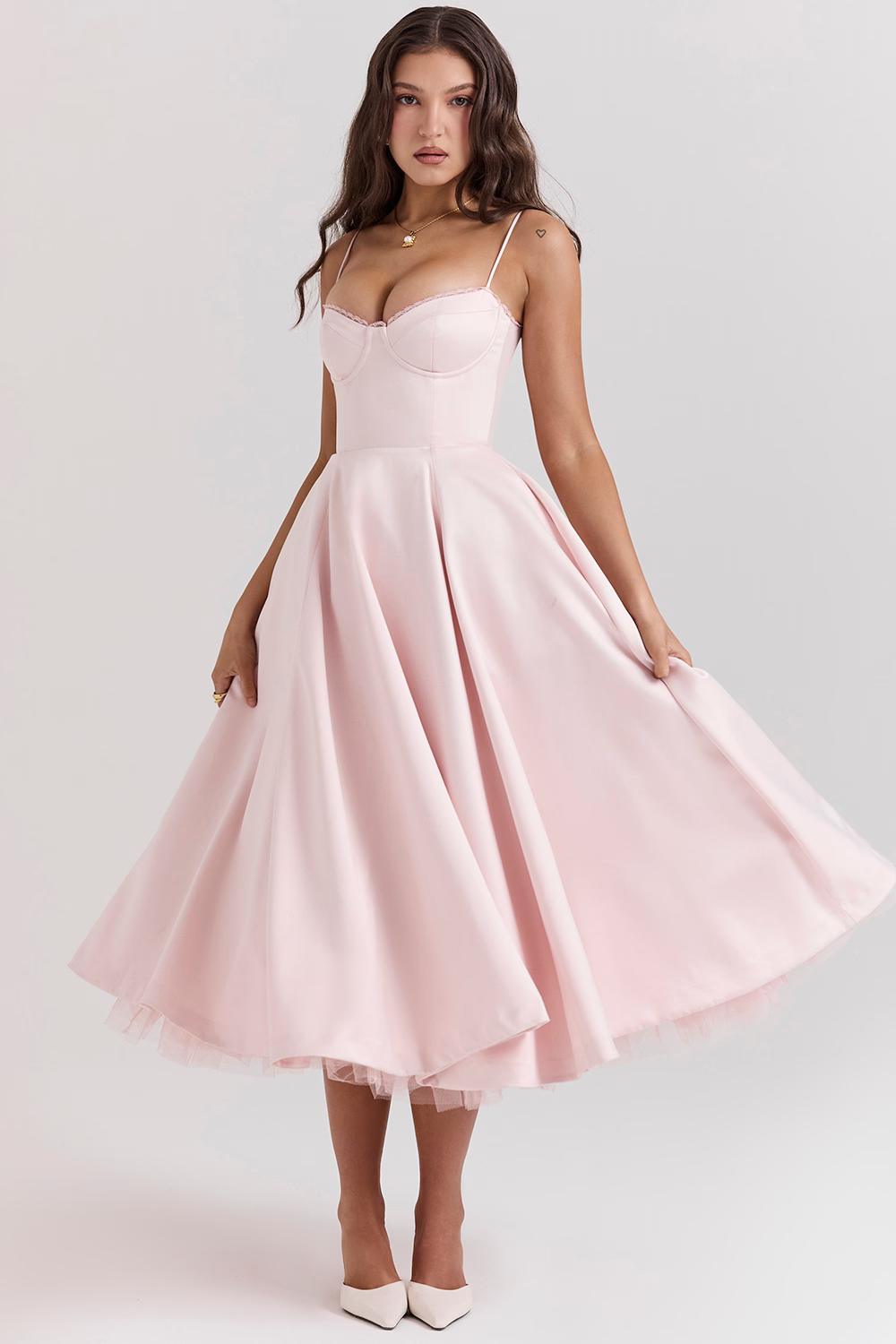 Woman wearing a pink dress on a white background