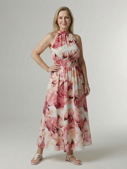 Woman wearing a floral dress against a plain background