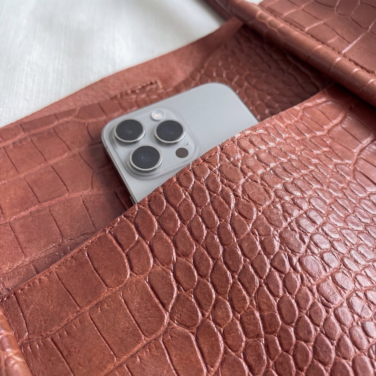 Brown textured tote bag with a phone inside