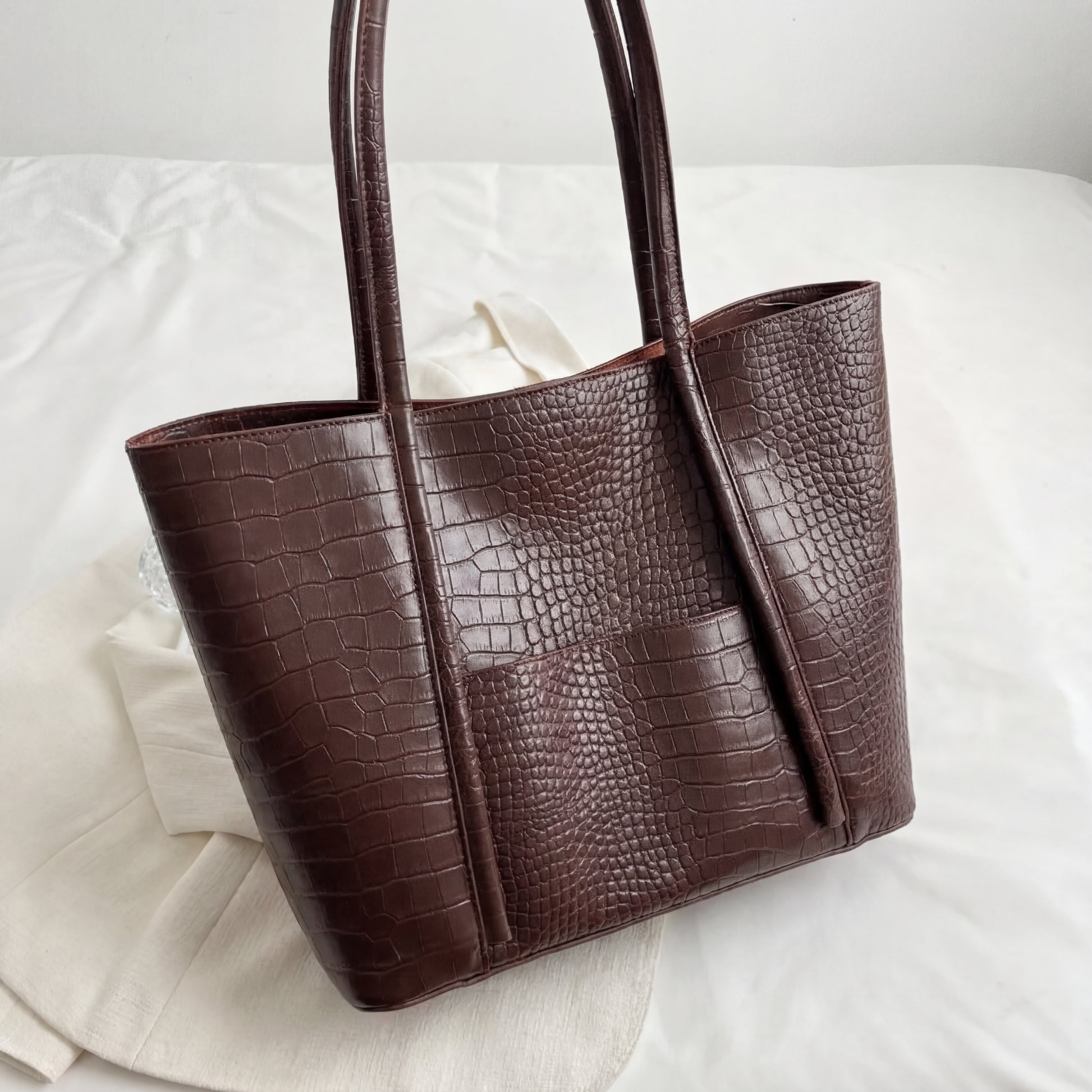 Dark brown textured tote bag on a light background