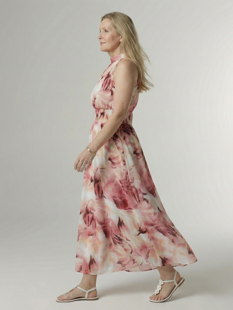 Woman wearing a floral dress on a plain background