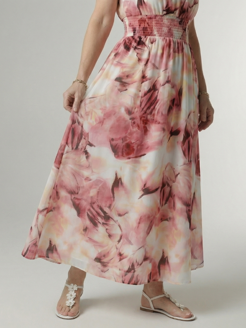 Woman wearing a floral dress on a plain background