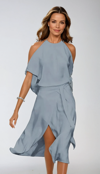 Woman wearing a light blue dress against a white background