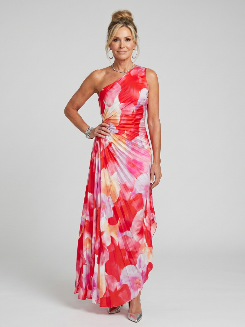 Woman wearing a one-shoulder floral dress on a plain background