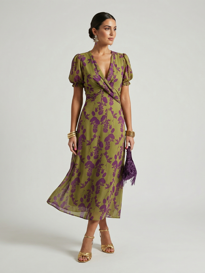 Woman wearing a green and purple floral dress on a white background