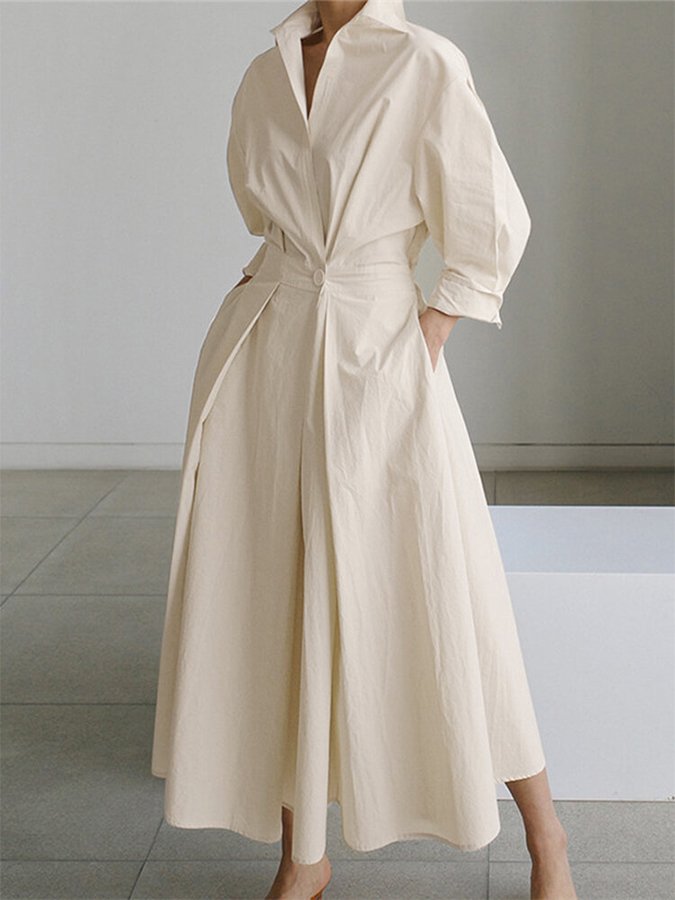 Beige dress worn by a person on a neutral background