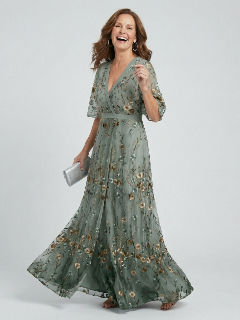 Woman wearing a green floral dress on a white background