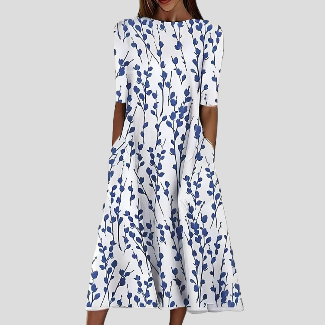 White dress with blue floral pattern on a gray background