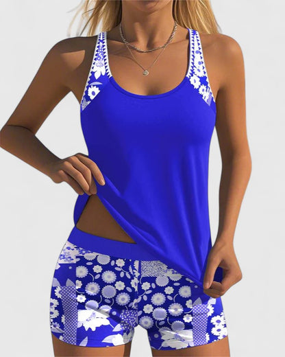 Woman wearing a blue and white floral sports outfit on a plain background