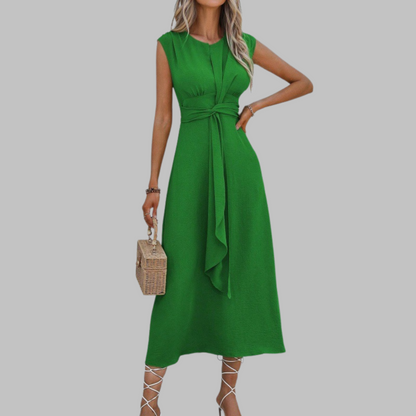 Green dress worn by a model on a gray background