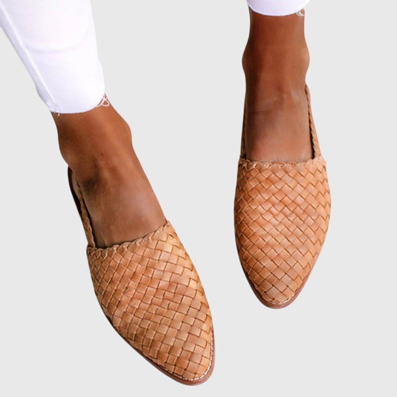 Woven brown flat shoes on a white background