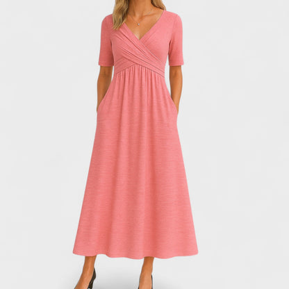 Pink dress with a V-neck and short sleeves on a white background