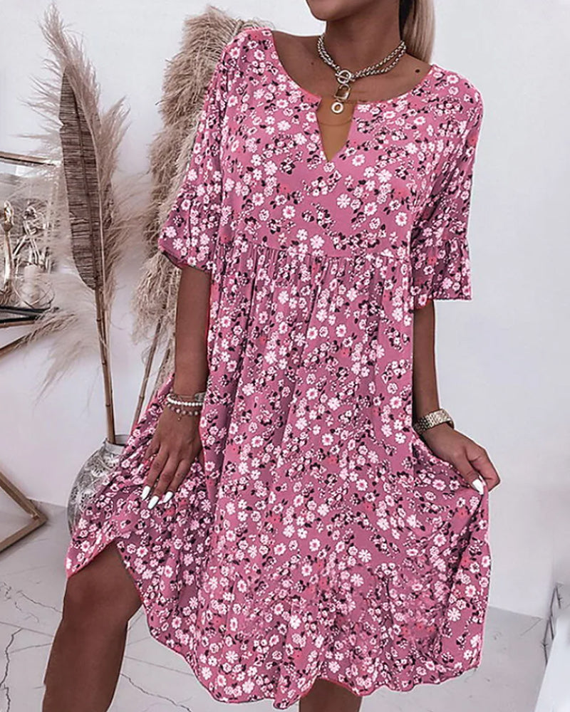 Woman wearing a pink floral dress with a white background