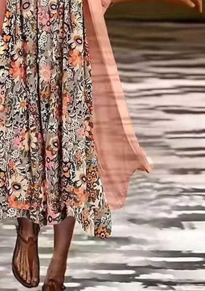 Person wearing a floral dress with a blurred background
