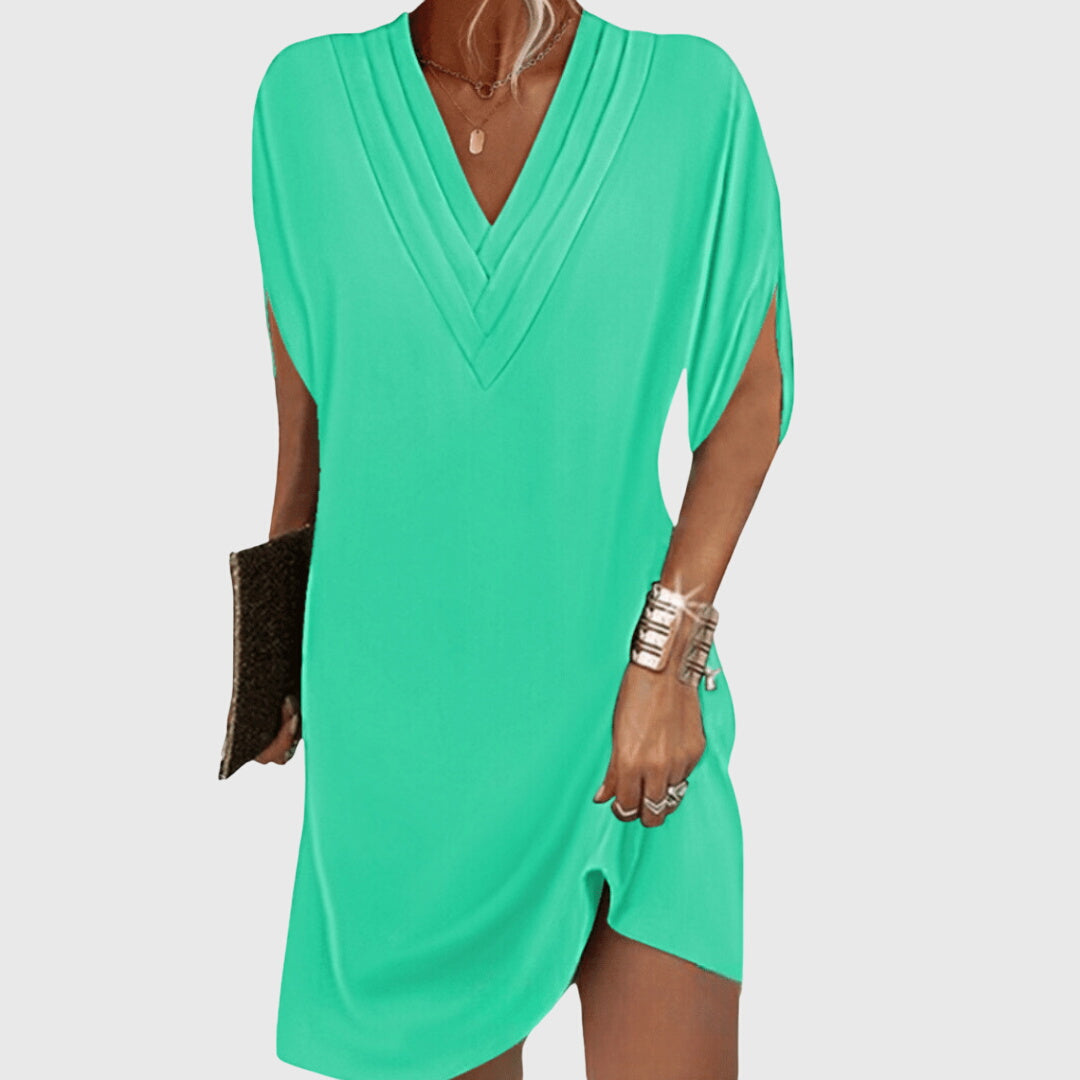 Green dress worn by a person on a white background