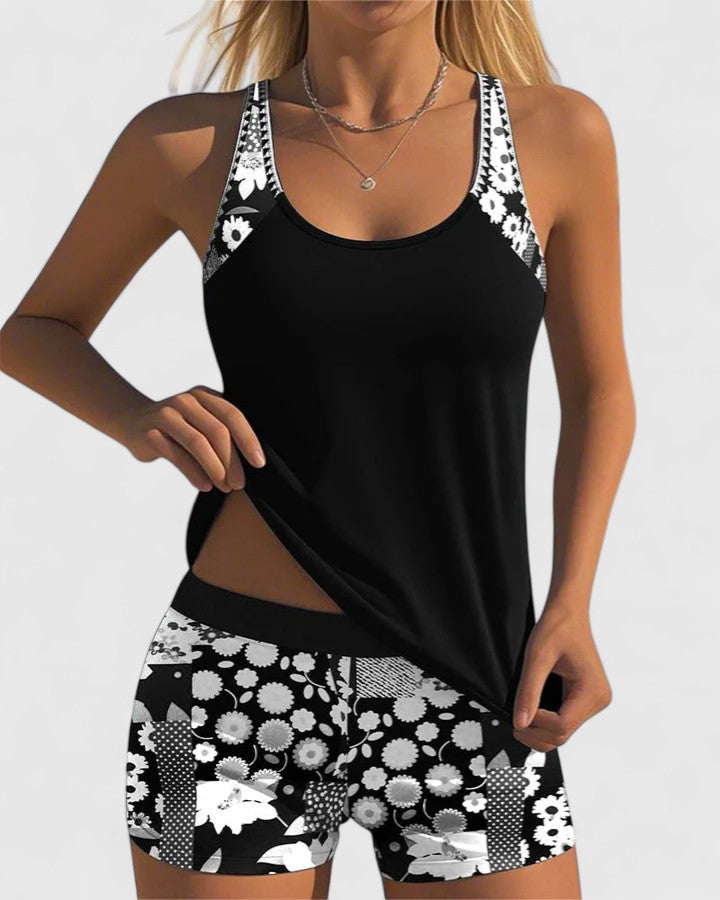 Black tank top and floral shorts set on a white background