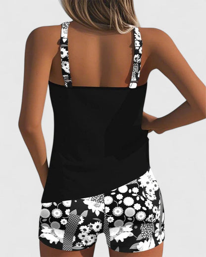 Black tank top and floral shorts set on a plain background