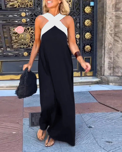 Woman wearing a black and white dress standing in front of a decorative door.
