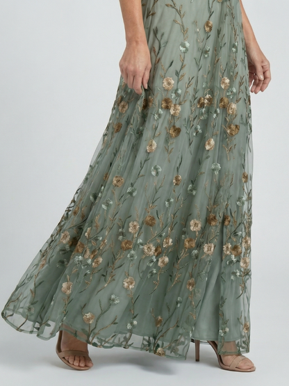 Long floral dress with a subtle pattern on a plain background