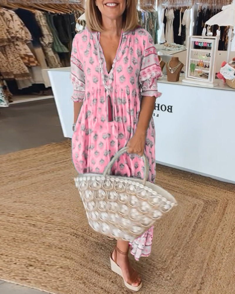 Woman in a pink dress holding a clear handbag in a store setting