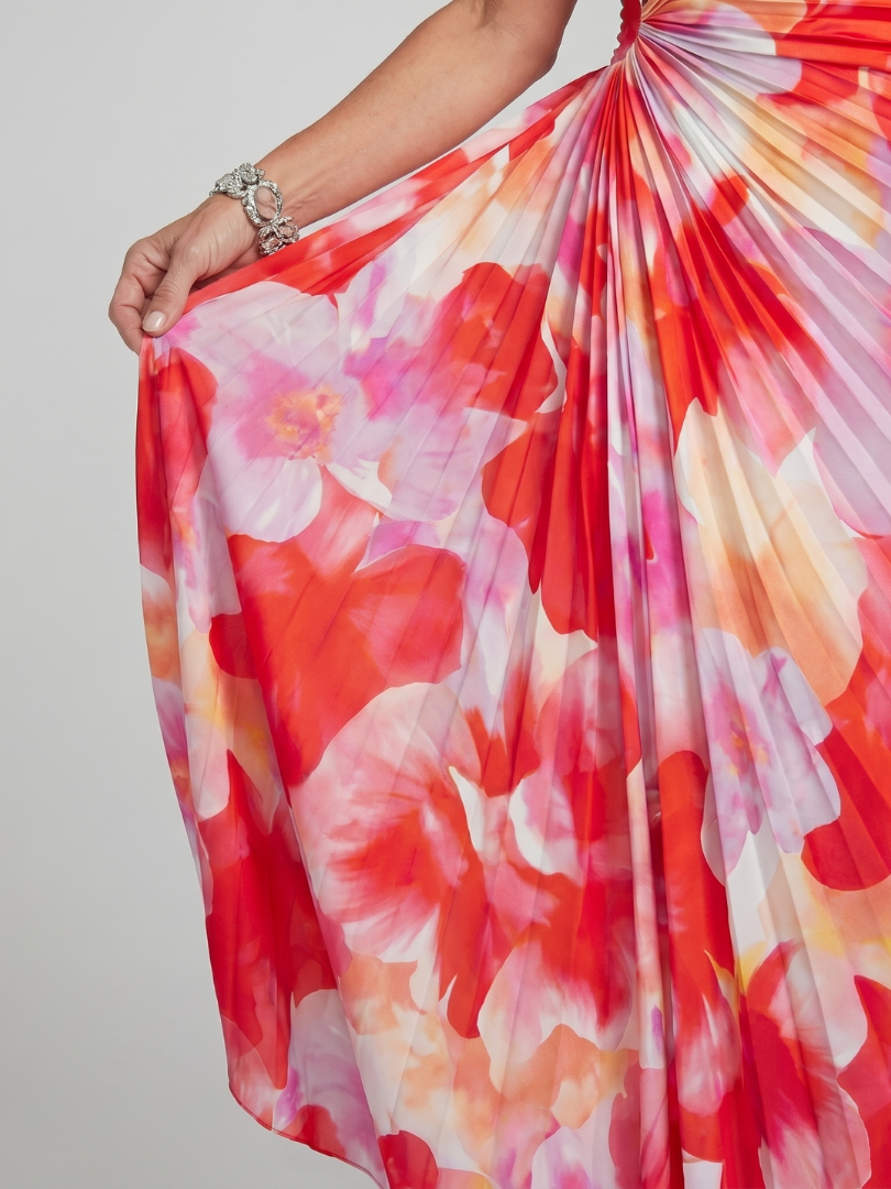 Colorful floral dress with red, orange, and white flowers on a plain background