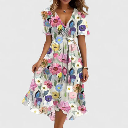Woman wearing a colorful floral dress on a white background