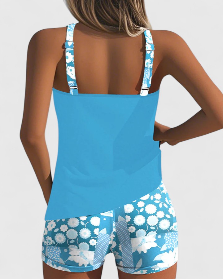 Blue floral swimsuit on a plain background