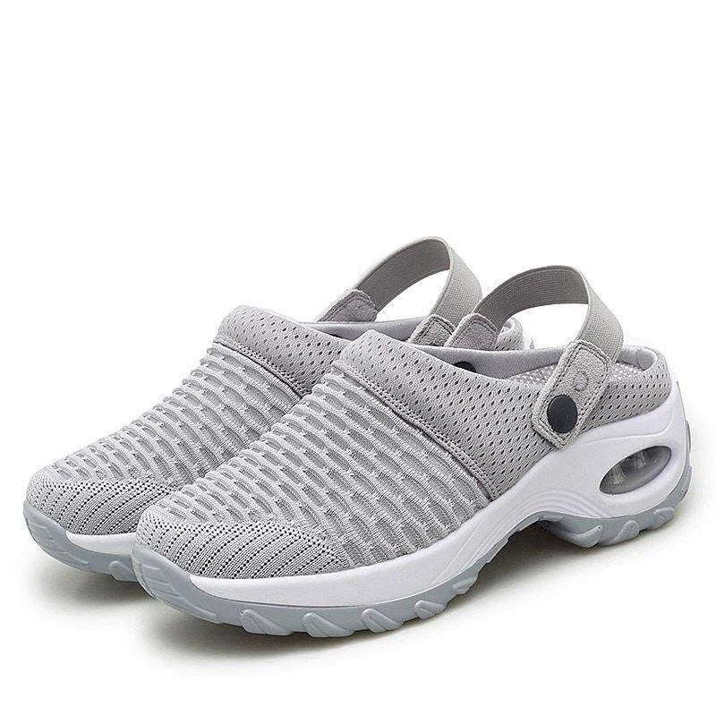Gray clogs with white soles on a white background