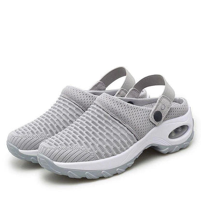 Gray clogs with white soles on a white background