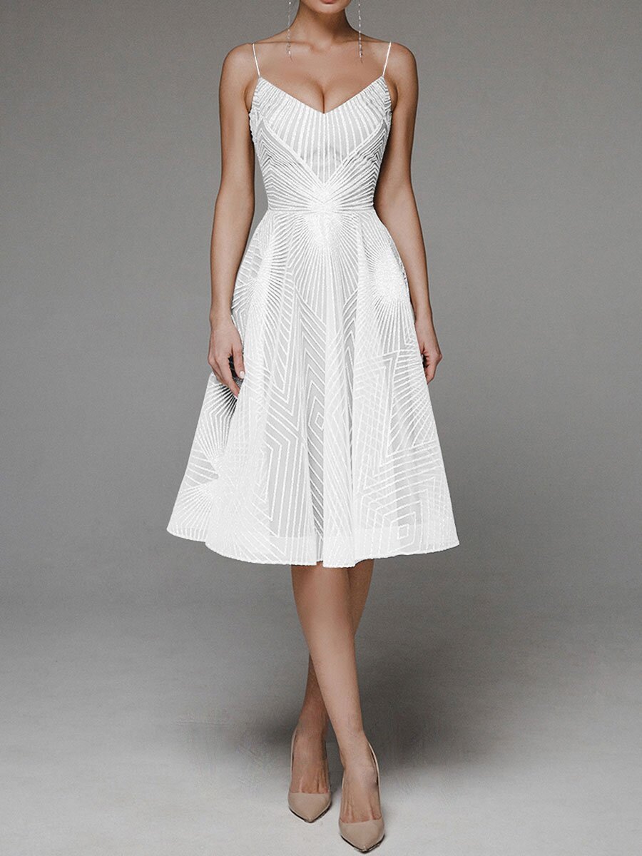 White dress with intricate detailing on a gray background