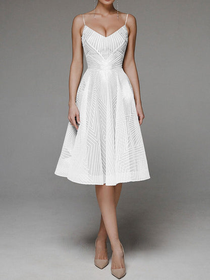 White dress with intricate detailing on a gray background