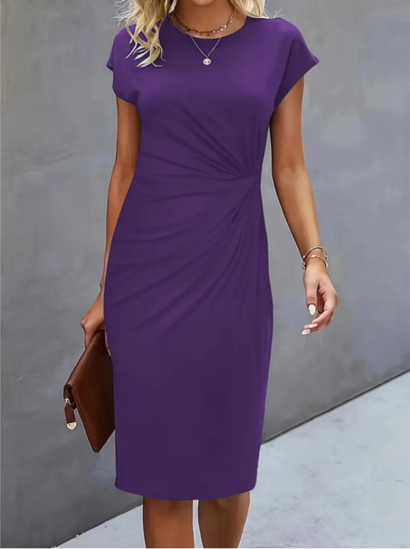 Woman wearing a purple dress against a gray background