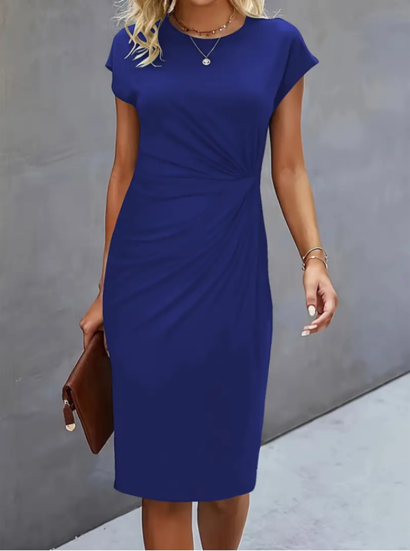 Woman wearing a blue dress against a gray background