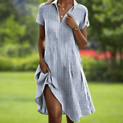 Woman wearing a blue and white striped dress in a garden setting